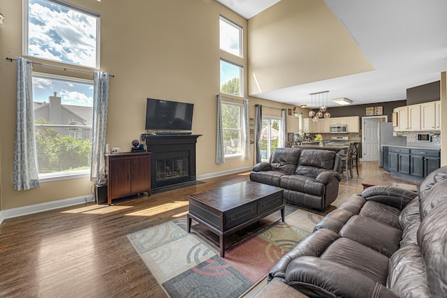 2316 Loop Rd, Algonquin, IL 60102 - living room with a high ceiling, a fireplace with flush hearth, and light wood-style floors