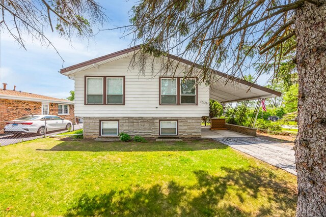 7325 173rd St, Tinley Park, IL 60477 - view of side of property with an attached carport, a lawn, and concrete driveway