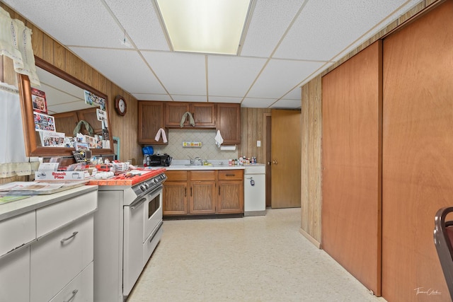 7325 173rd St, Tinley Park, IL 60477 - kitchen with light countertops, brown cabinetry, a sink, a drop ceiling, and light flooring