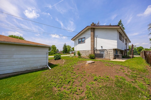 7325 173rd St, Tinley Park, IL 60477 - rear view of property with a chimney, stone siding, and cooling unit