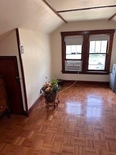corridor featuring vaulted ceiling and baseboards