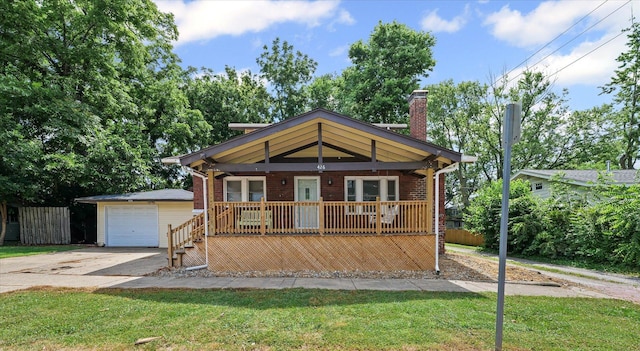 426 S Mcclellan St, Decatur, IL 62522 - view of front of home featuring a porch, driveway, an outdoor structure, a chimney, and brick siding