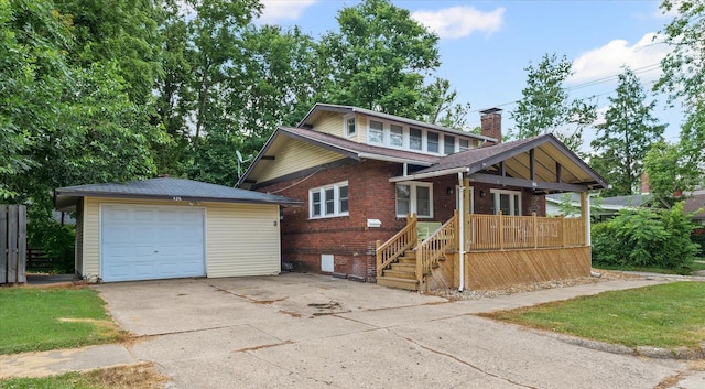 426 S Mcclellan St, Decatur, IL 62522 - view of front facade with a detached garage, an outdoor structure, concrete driveway, covered porch, and brick siding