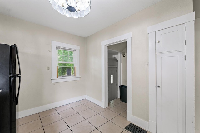 426 S Mcclellan St, Decatur, IL 62522 - unfurnished dining area featuring light tile patterned flooring and a chandelier