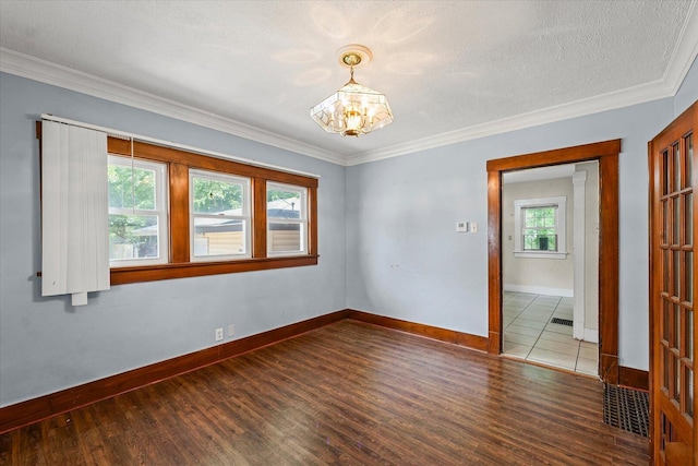 426 S Mcclellan St, Decatur, IL 62522 - spare room with a chandelier, wood finished floors, ornamental molding, and a textured ceiling