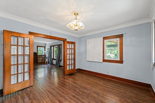 426 S Mcclellan St, Decatur, IL 62522 - spare room featuring french doors, a chandelier, dark wood-style flooring, and ornamental molding