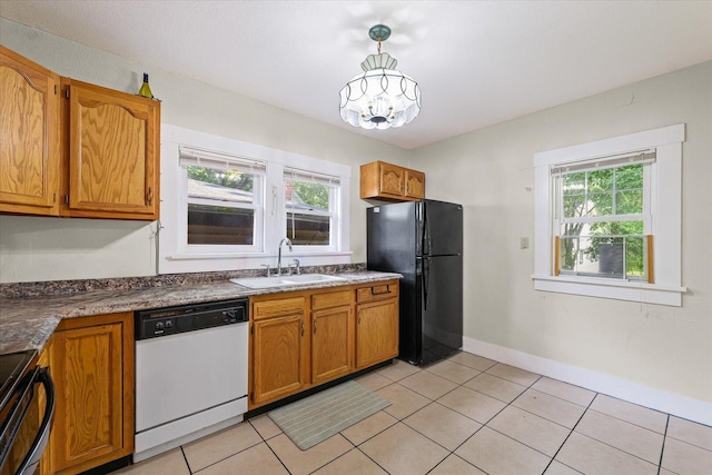 426 S Mcclellan St, Decatur, IL 62522 - kitchen featuring white dishwasher, freestanding refrigerator, range with electric cooktop, and brown cabinets
