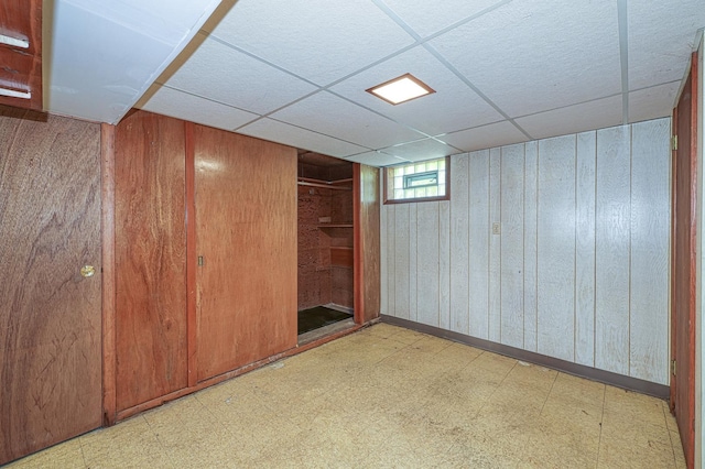 165 S Commonwealth Ave, Elgin, IL 60123 - basement with tile patterned floors, wood walls, and a paneled ceiling