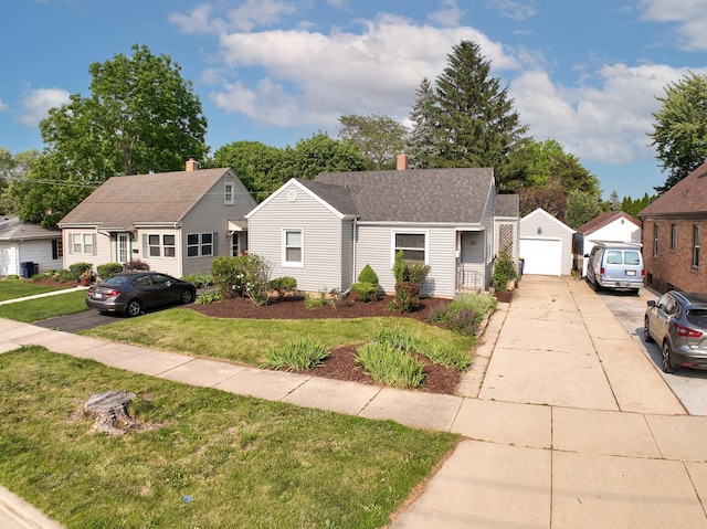 165 S Commonwealth Ave, Elgin, IL 60123 - view of front of property with a front lawn, a garage, an outbuilding, and concrete driveway