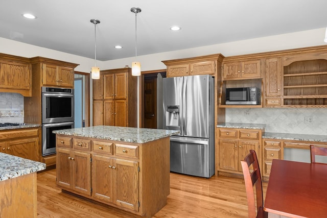 1364 Yorkshire Ln, Carol Stream, IL 60188 - kitchen featuring stainless steel appliances, decorative backsplash, a center island, light wood finished floors, and hanging light fixtures
