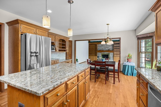 1364 Yorkshire Ln, Carol Stream, IL 60188 - kitchen with appliances with stainless steel finishes, brown cabinets, light wood finished floors, light stone counters, and recessed lighting