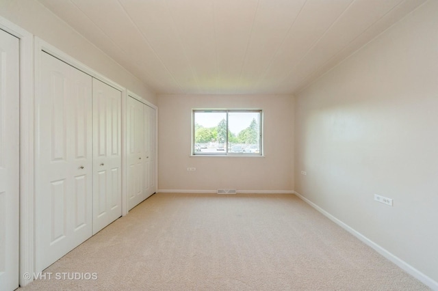 127 N Wolf Rd Unit 52A, Wheeling, IL 60090 - unfurnished bedroom with two closets and light carpet