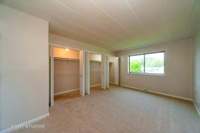 127 N Wolf Rd Unit 52A, Wheeling, IL 60090 - unfurnished bedroom with multiple closets and light colored carpet