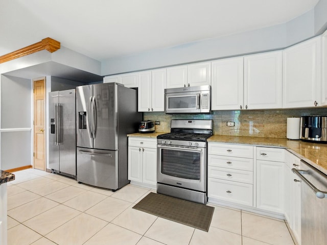 1386 Laurel Oaks Dr, Streamwood, IL 60107 - kitchen featuring stainless steel appliances, white cabinetry, light tile patterned floors, and backsplash