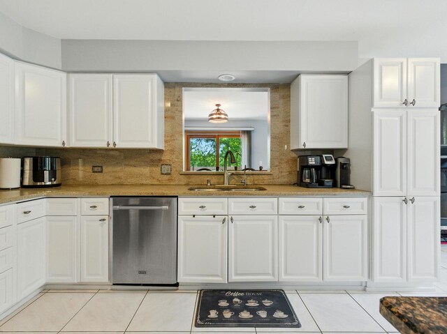1386 Laurel Oaks Dr, Streamwood, IL 60107 - kitchen with stainless steel dishwasher, light tile patterned flooring, decorative backsplash, and white cabinets