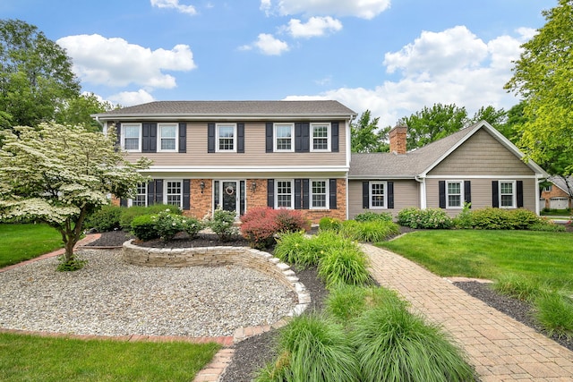 833 Manassas Ct, Naperville, IL 60540 - colonial-style house featuring a front yard, a chimney, and brick siding
