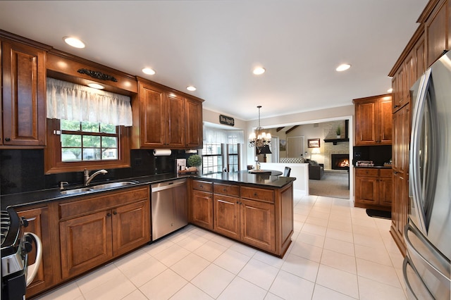 833 Manassas Ct, Naperville, IL 60540 - kitchen featuring appliances with stainless steel finishes, a chandelier, dark countertops, decorative backsplash, and ornamental molding