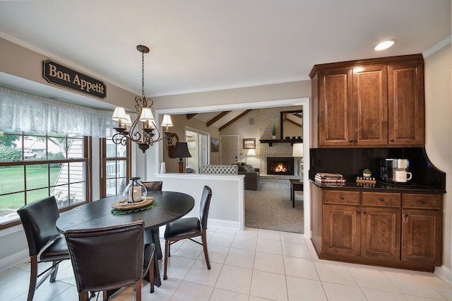 833 Manassas Ct, Naperville, IL 60540 - dining area featuring a chandelier, a brick fireplace, light tile patterned floors, ornamental molding, and light colored carpet