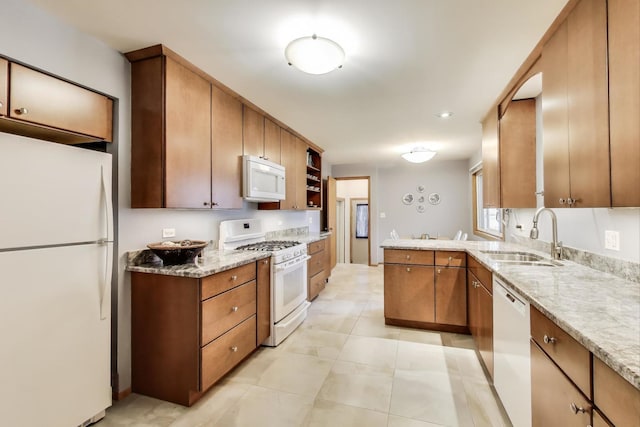 539 S Evergreen Ave, Arlington Heights, IL 60005 - kitchen with white appliances, brown cabinetry, light stone countertops, and a peninsula