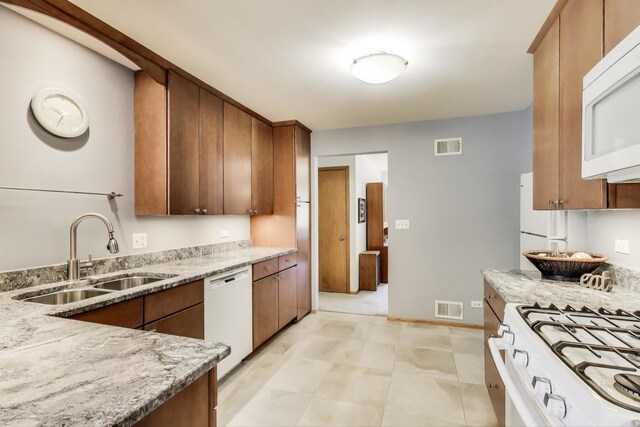 539 S Evergreen Ave, Arlington Heights, IL 60005 - kitchen featuring white appliances, light stone counters, and brown cabinetry