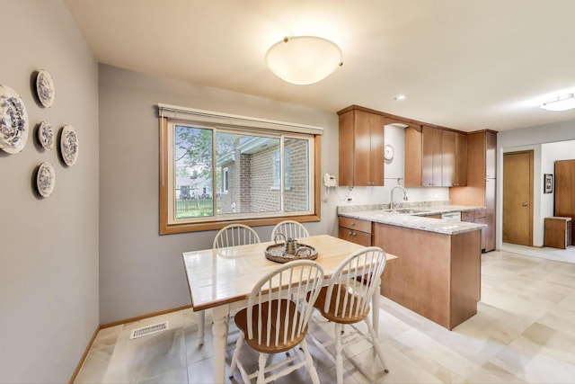 539 S Evergreen Ave, Arlington Heights, IL 60005 - kitchen featuring a peninsula, brown cabinets, light stone counters, white dishwasher, and recessed lighting