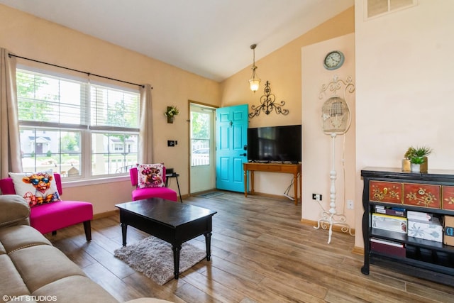 4321 Dillon St, Plano, IL 60545 - living room featuring vaulted ceiling and wood finished floors