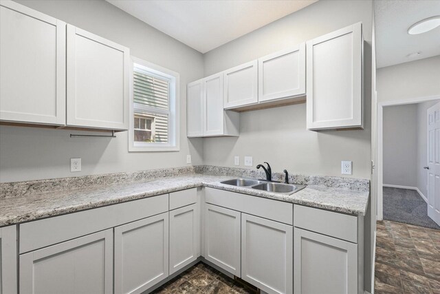 1391 W Decatur St, Decatur, IL 62522 - kitchen featuring stone finish flooring, light countertops, and white cabinets