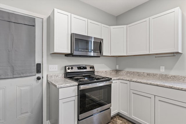 1391 W Decatur St, Decatur, IL 62522 - kitchen with stainless steel appliances, light countertops, and white cabinets