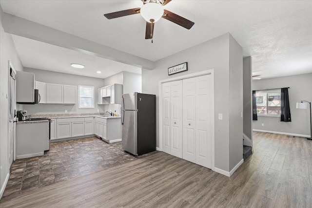 1391 W Decatur St, Decatur, IL 62522 - kitchen featuring stainless steel appliances, ceiling fan, wood finished floors, light countertops, and white cabinetry