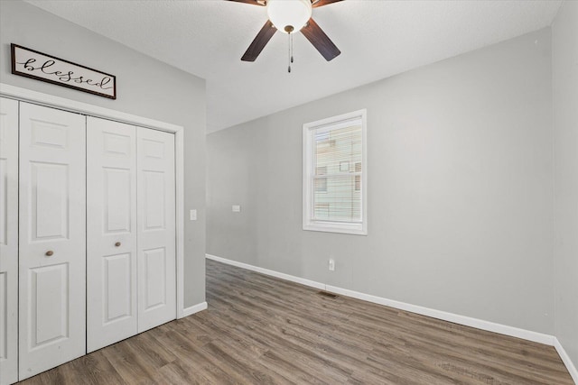 1391 W Decatur St, Decatur, IL 62522 - unfurnished bedroom with wood finished floors, a closet, and a ceiling fan