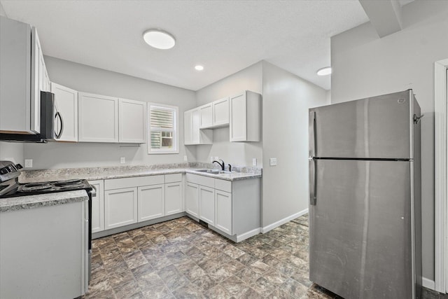1391 W Decatur St, Decatur, IL 62522 - kitchen with appliances with stainless steel finishes, light countertops, white cabinets, and stone finish floors