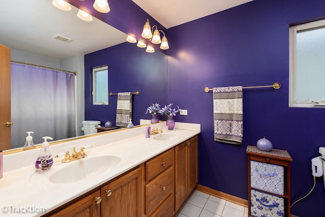 6158 W 60th St, Chicago, IL 60638 - bathroom featuring toilet, double vanity, tile patterned flooring, and baseboards