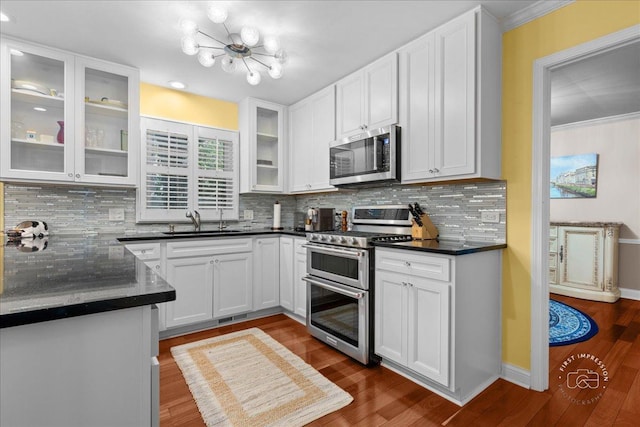1519 Wedgefield Cir, Naperville, IL 60563 - kitchen with appliances with stainless steel finishes, a chandelier, white cabinets, decorative backsplash, and dark wood-style flooring