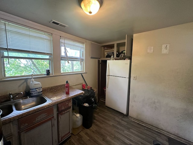 15201 Turlington Ave, Harvey, IL 60426 - kitchen with freestanding refrigerator, a sink, dark wood-style flooring, and dark countertops