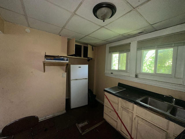 15201 Turlington Ave, Harvey, IL 60426 - kitchen with freestanding refrigerator, a paneled ceiling, a sink, and dark countertops