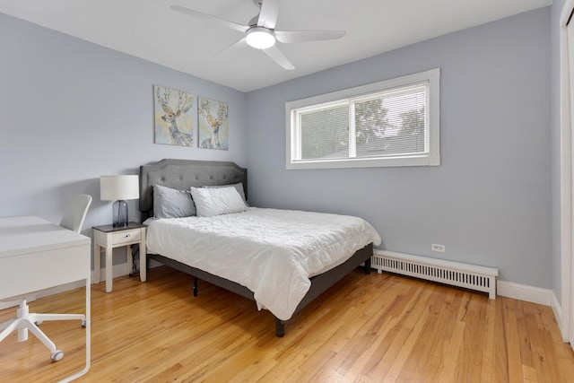 1107 Washington Blvd Unit 2E, Oak Park, IL 60302 - bedroom with a baseboard heating unit, light wood finished floors, and ceiling fan
