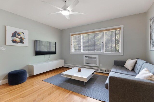 1107 Washington Blvd Unit 2E, Oak Park, IL 60302 - living area with healthy amount of natural light, wood finished floors, a ceiling fan, and a wall unit AC