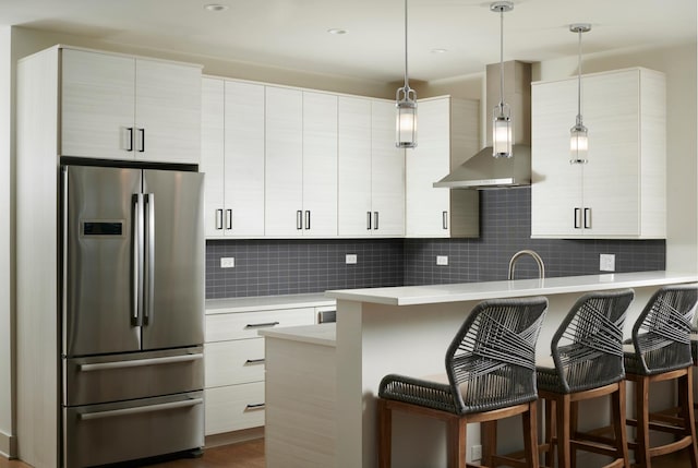 3828 N Racine Ave Unit 3, Chicago, IL 60613 - kitchen featuring freestanding refrigerator, a breakfast bar area, light countertops, and decorative light fixtures