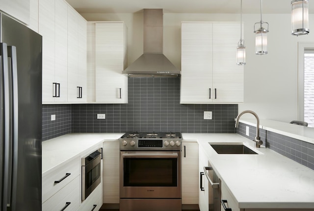 3828 N Racine Ave Unit 3, Chicago, IL 60613 - kitchen featuring appliances with stainless steel finishes, wall chimney exhaust hood, tasteful backsplash, hanging light fixtures, and white cabinetry