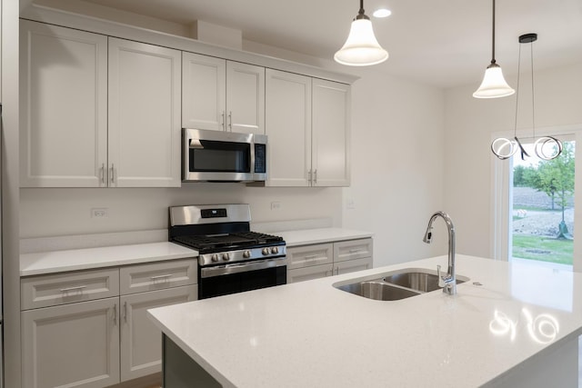 LOT15 Amherst Dr Unit B, Sycamore, IL 60178 - kitchen featuring stainless steel appliances, a sink, an island with sink, and decorative light fixtures