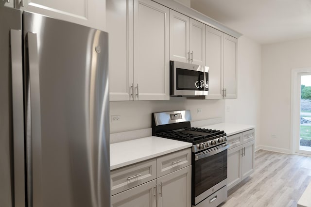 LOT15 Amherst Dr Unit B, Sycamore, IL 60178 - kitchen featuring appliances with stainless steel finishes, light wood finished floors, light countertops, and baseboards