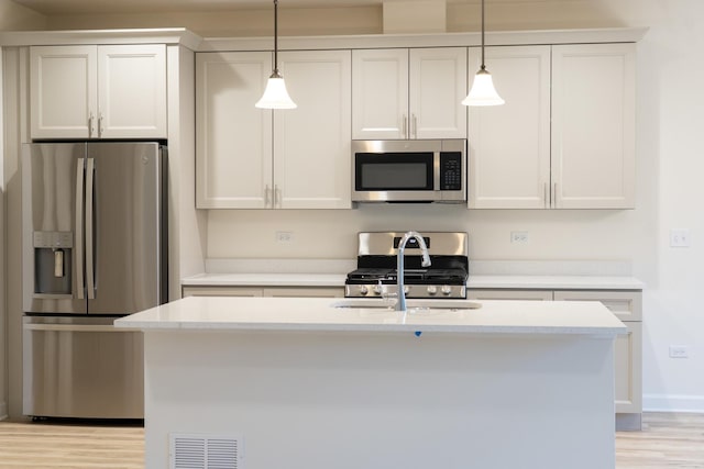 LOT15 Amherst Dr Unit B, Sycamore, IL 60178 - kitchen with appliances with stainless steel finishes, light countertops, pendant lighting, and light wood-style floors