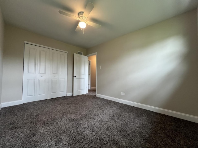 6047 Elm Ln, Matteson, IL 60443 - unfurnished bedroom featuring dark carpet, baseboards, a closet, and ceiling fan