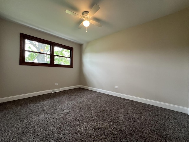 6047 Elm Ln, Matteson, IL 60443 - empty room featuring a ceiling fan, dark colored carpet, and baseboards