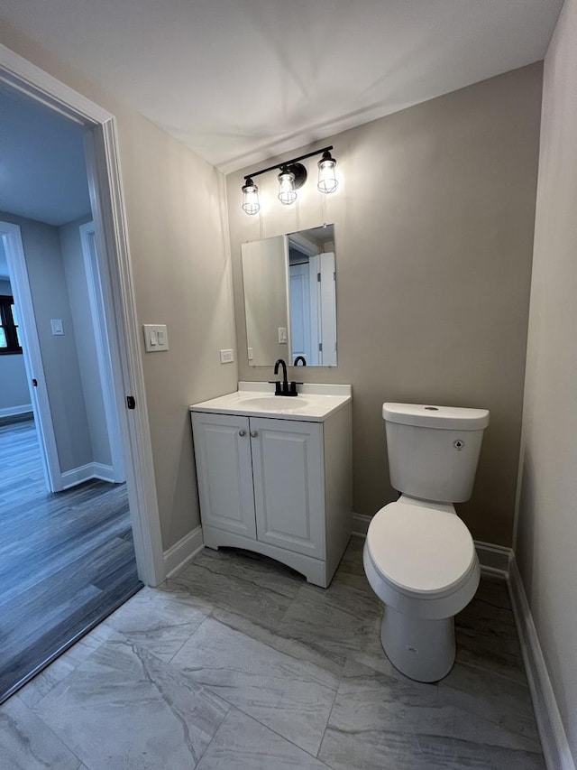 6047 Elm Ln, Matteson, IL 60443 - bathroom with vanity, toilet, baseboards, and marble look tiles