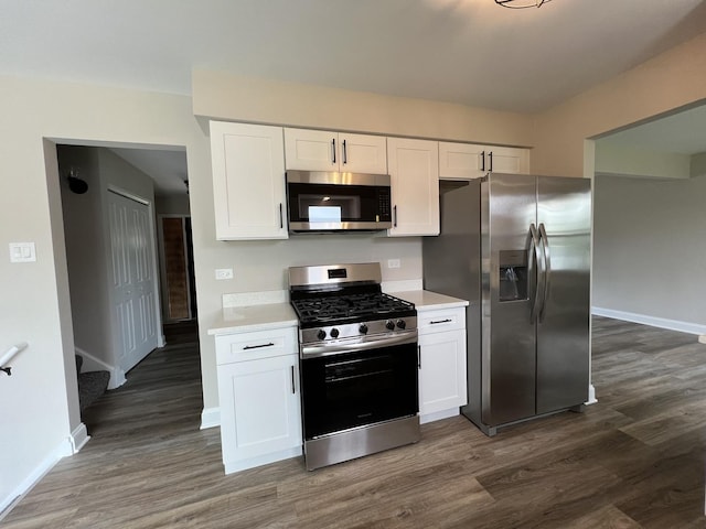 6047 Elm Ln, Matteson, IL 60443 - kitchen featuring appliances with stainless steel finishes, dark wood-style flooring, light countertops, and white cabinetry