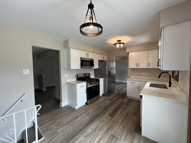 6047 Elm Ln, Matteson, IL 60443 - kitchen with stainless steel appliances, a sink, dark wood finished floors, white cabinets, and baseboards
