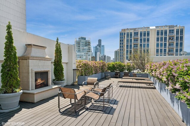 758 N Larrabee St Unit 427, Chicago, IL 60654 - wooden deck with a tile fireplace and a skyline view