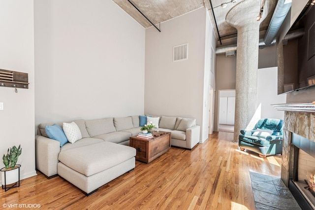 758 N Larrabee St Unit 427, Chicago, IL 60654 - living room featuring light wood finished floors, a tile fireplace, and a high ceiling