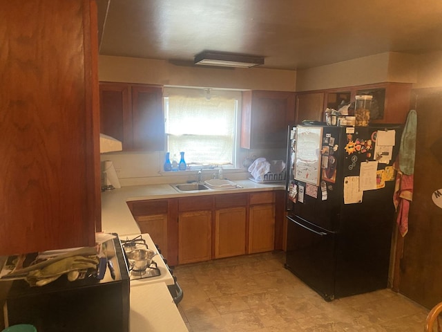 7545 Beloit Ave, Bridgeview, IL 60455 - kitchen with freestanding refrigerator, a sink, light countertops, and brown cabinets